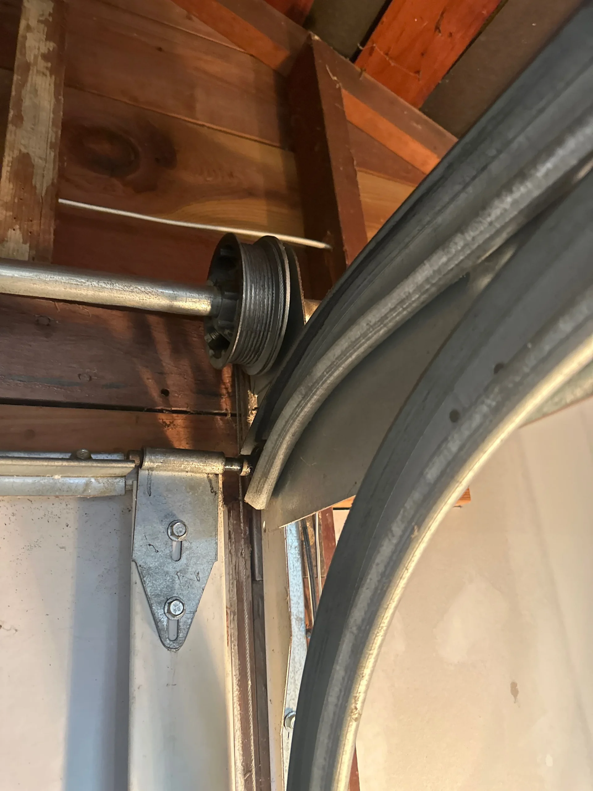 Local-Garage-Doors-installed-a-pair-of-garage-door-cables-in-Tustin, CA_converted Garage door hinges installed on a residential garage door in Tustin, CA