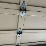 Garage door hinges installed on a residential garage door in Stanton-CA