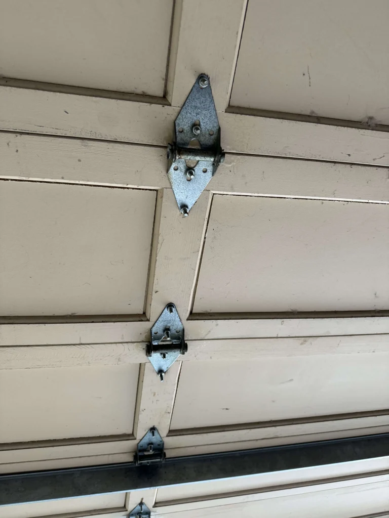Garage door hinges installed on a residential garage door in Stanton-CA