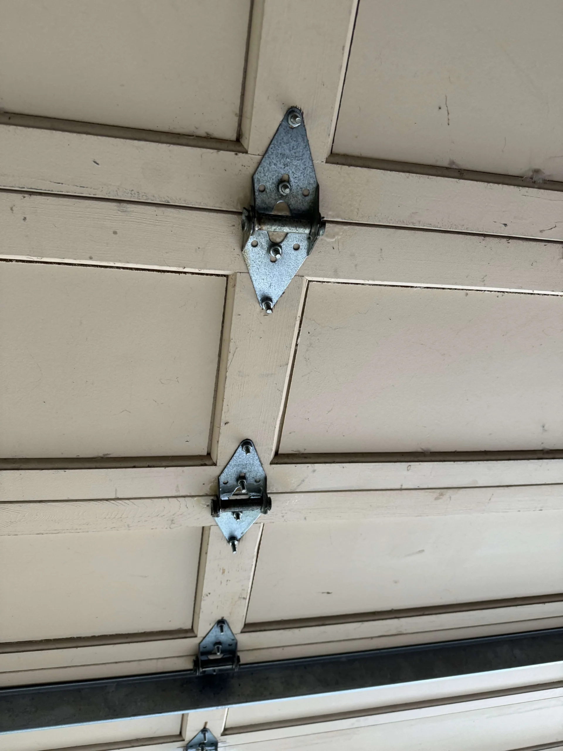 Garage door hinges installed on a residential garage door in Stanton-CA